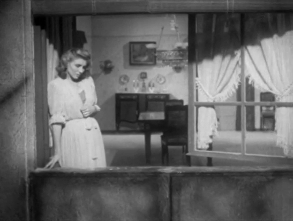 Plano secuencia con movimiento de cámara que sigue a Ana y sale por la ventana, augurando un acontecimiento después del anuncio del estallido de la Guerra Civil. A lo Max Ophüls. Vida en sombras. Llobet-Gràcia.